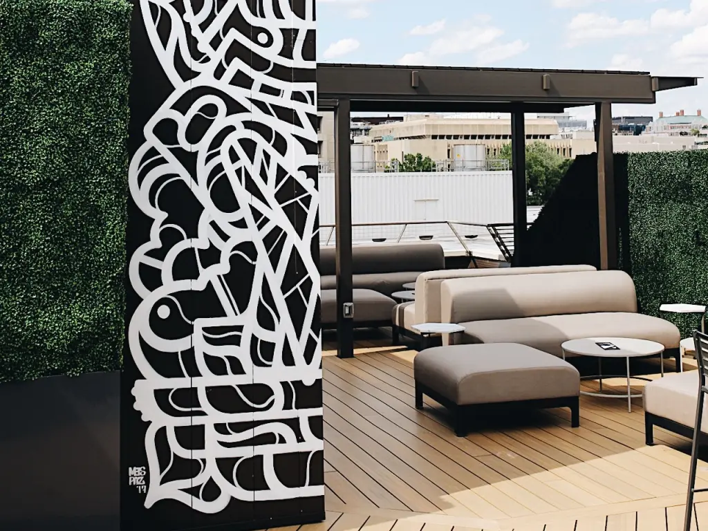 Outdoor area at Hotel Hive, with modern graffiti artwork and outdoor seating on the rooftop lounge