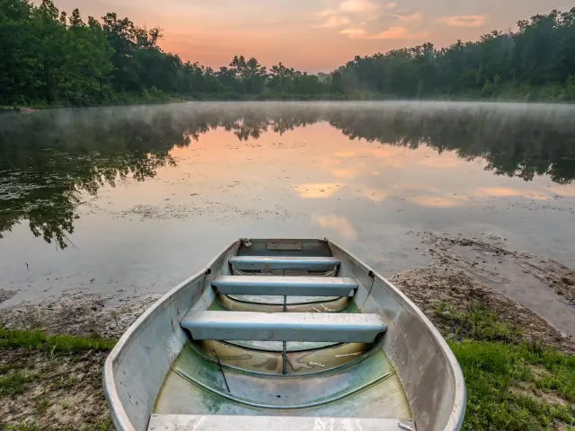 Lone row boat bobbing on Lake of the Ozarks, Missouri, Texas, USA