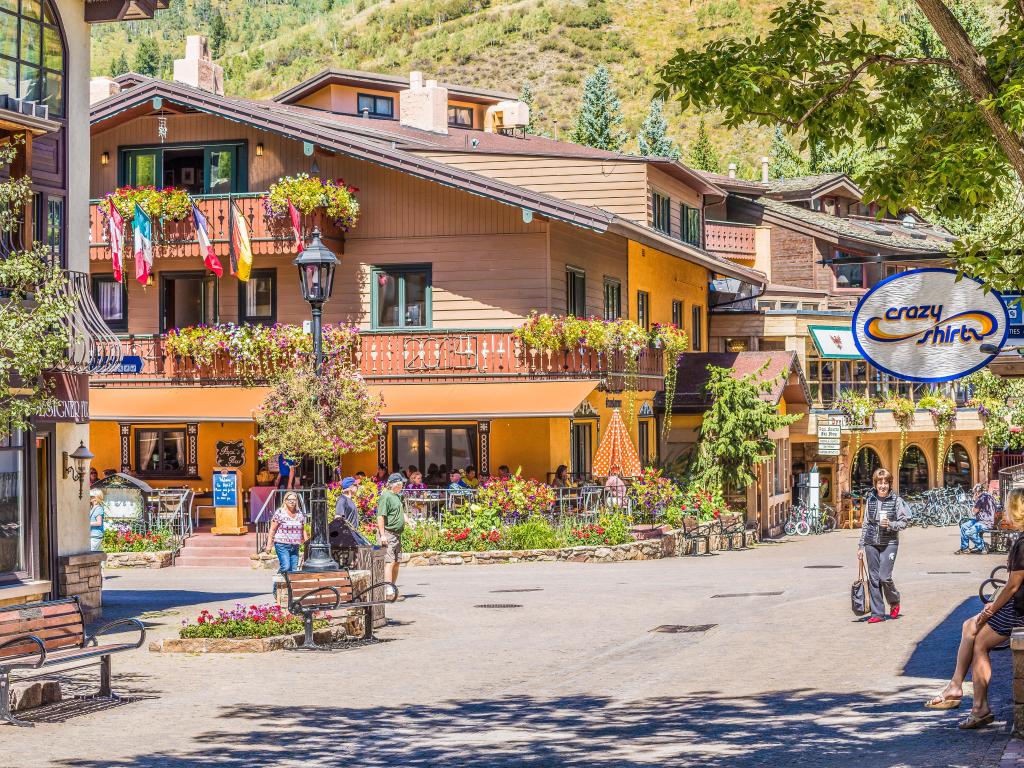 Swiss style chalet buildings lining a street in Vail Town, Colorado on a summer's day, with flowers adorning the buildings