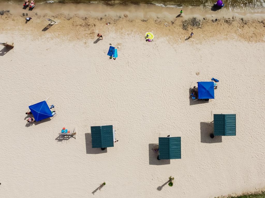 Top view umbrellas and beach activities on sandy shorelines at City Beach Park in Granbury, Texas