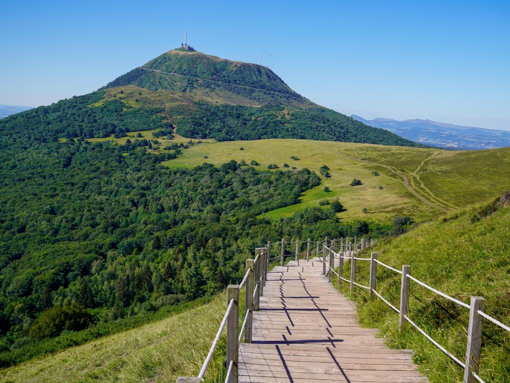 Wooden walking pathway in Puy De Dome French mountain volcano in summer day