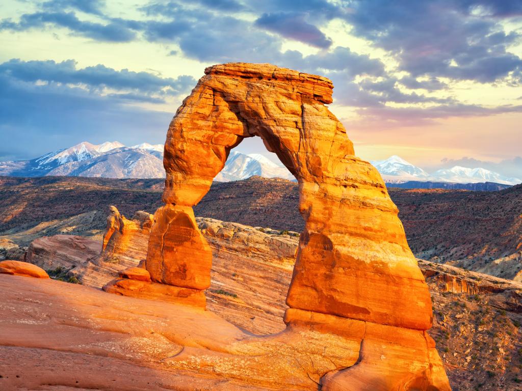 Arches National Park, Utah, USA with a delicate arch taken at sunset overlooking the stunning rocky landscape beyond. 