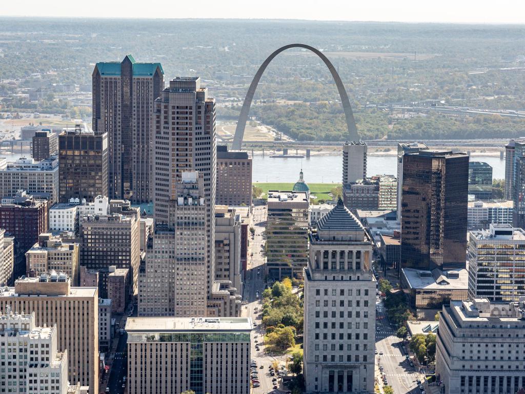 Aerial view of the St Louis downtown skyline, with the arch and river in the background