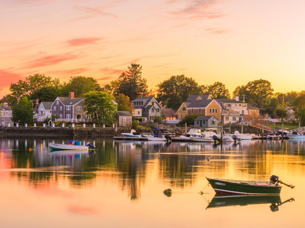 Portsmouth, New Hampshire, USA townscape during a colorful sunset. There is a boat in the foreground. 