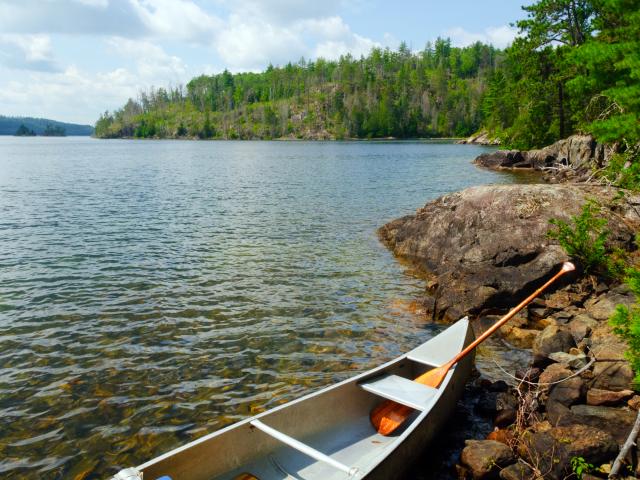 Canoe and oar on the rocks of Knife Lake in Quetico Provincial Park, Canada