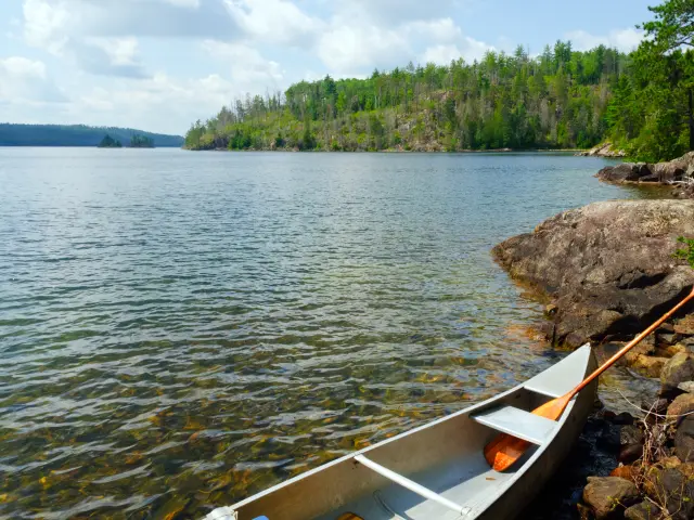 Canoe and oar on the rocks of Knife Lake in Quetico Provincial Park, Canada