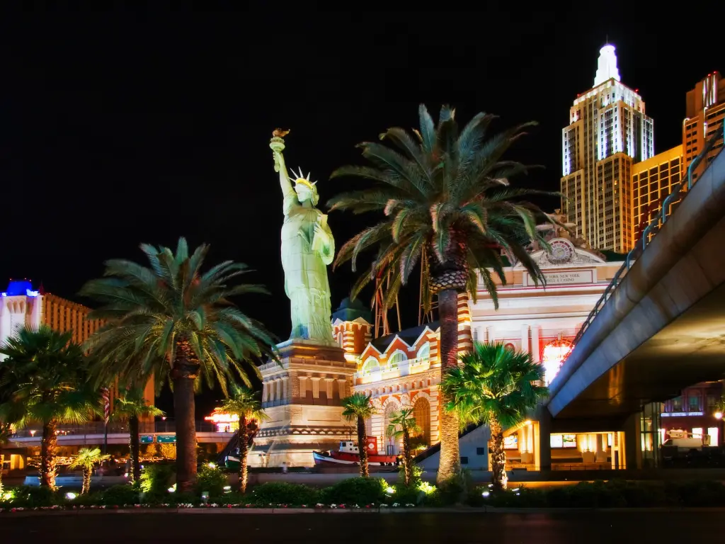 Night lights in Las Vegas, a small replica of the State of Liberty in focus
