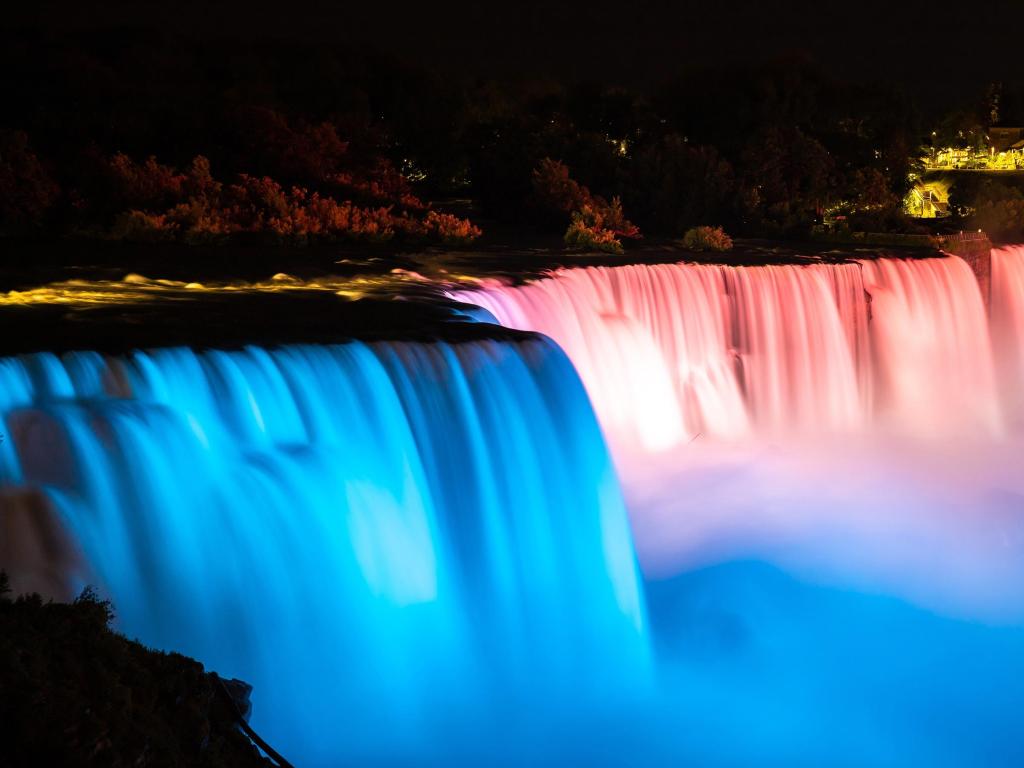 Night view of blue and red illuminated American falls at Niagara falls
