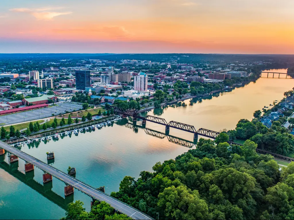 Aerial photo of Augusta, Georgia and the Savannah River at dusk, with an orange hued sky above