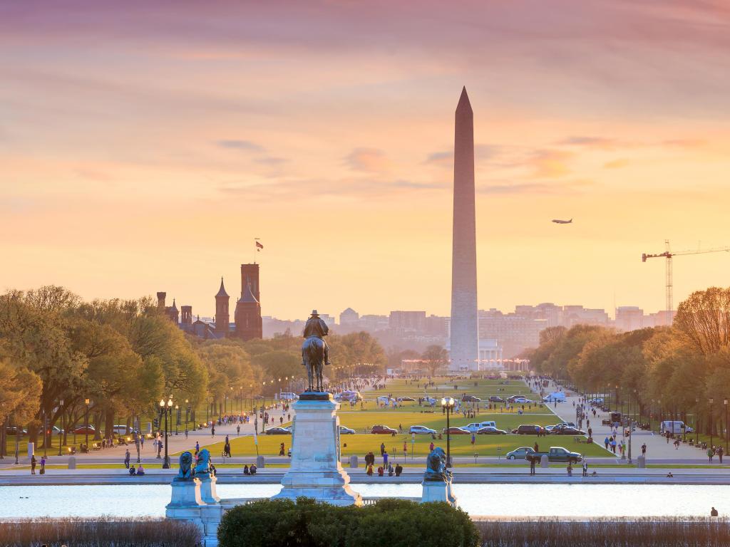 Washington DC, USA with a city view at a orange sunset, including Washington Monument from Capitol building.