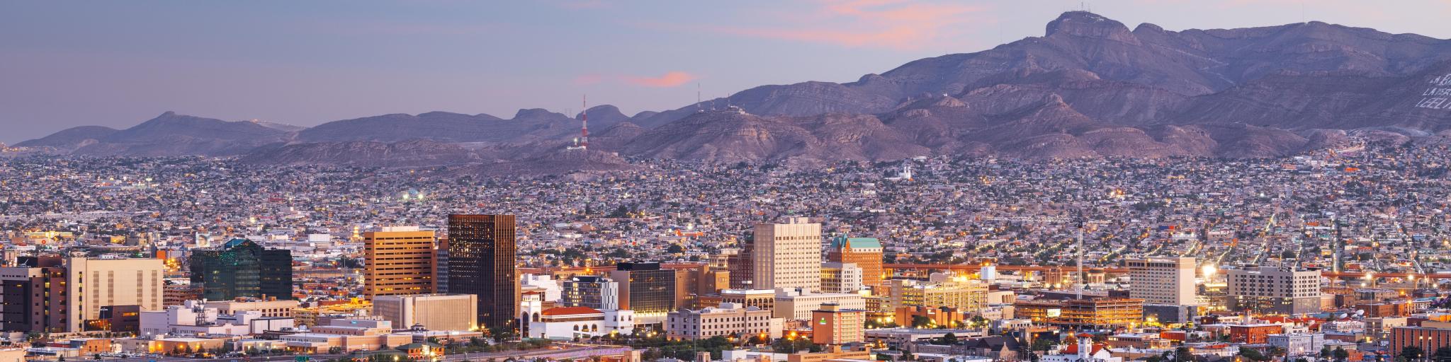 El Paso, Texas, USA with the downtown city skyline at dusk with Juarez, Mexico in the distance.