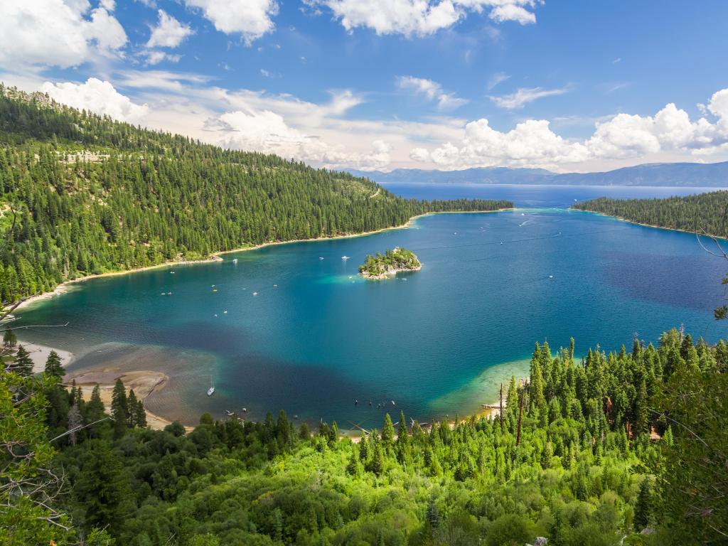 Emerald Bay, Lake Tahoe on a sunny day with blue waters surrounded by lush trees