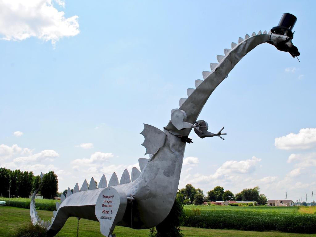 A roadside attraction, this metal dragon wears a top hat and breathes coin-operated flames. 