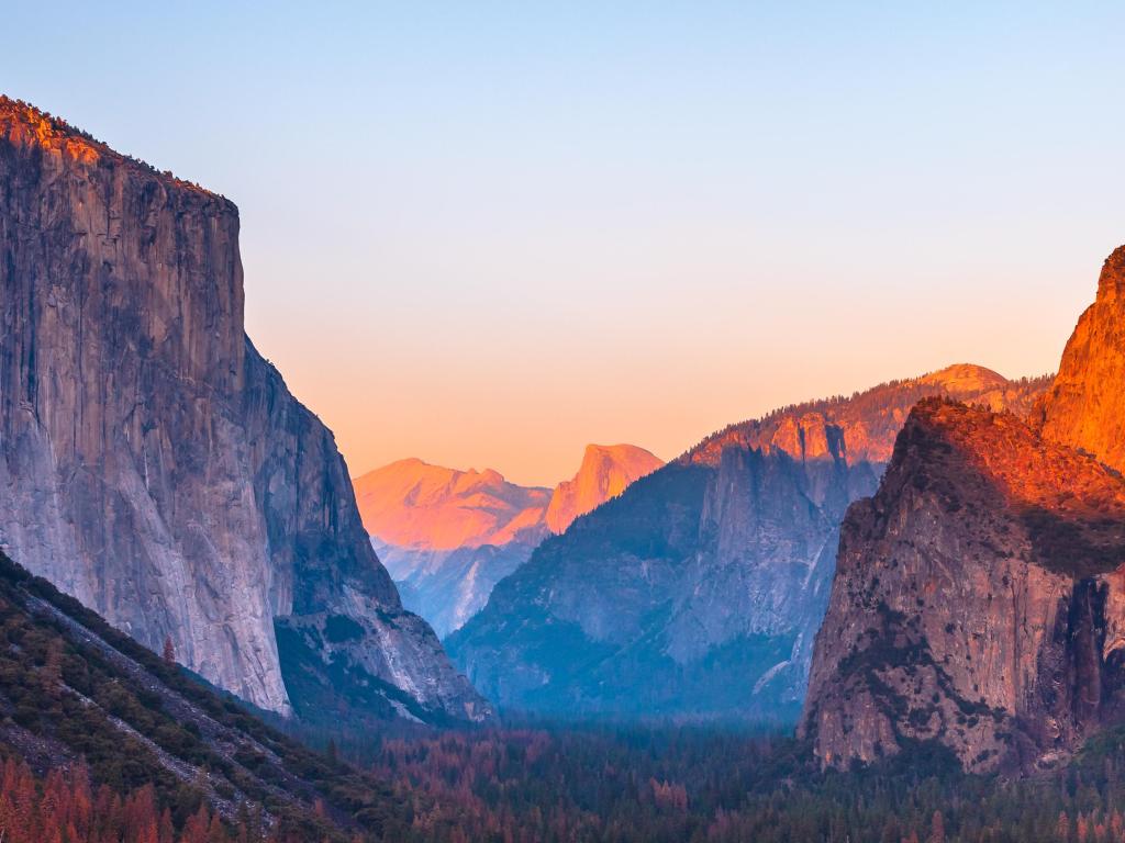 Yosemite National Park Tunnel View overlook at sunset. Front view panorama of popular El Capitan and Half Dome at deep red sunset. 
