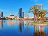 Orlando Lake Eola in the morning with urban skyscrapers and clear blue sky.