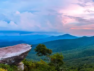 View over forested mountains and valleys from a high vantage point