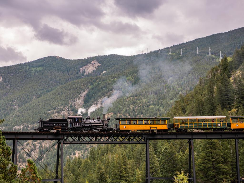 Famous train crossing over a bridge in the mountains on a cloudy day