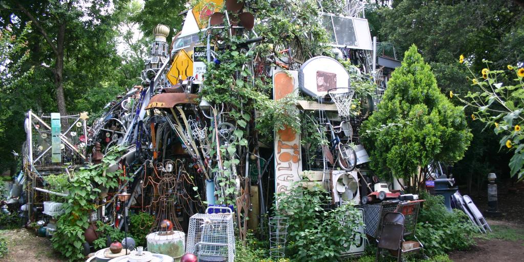 Cathedral of Junk, Austin with leaves growing on the outside 