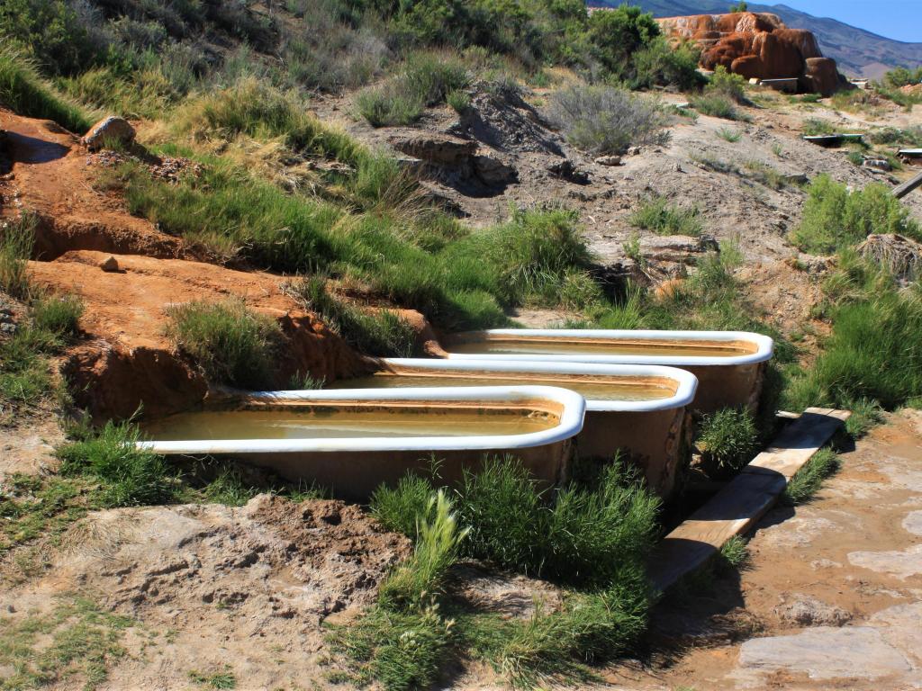 Bath tubs filled with natural hot springs water in empty wild landscape