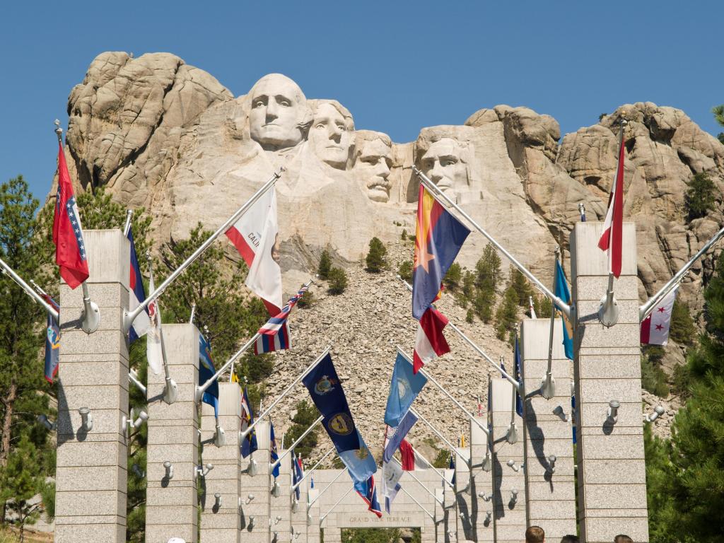 Flags from each US state line the way with views of Mount Rushmore in the background