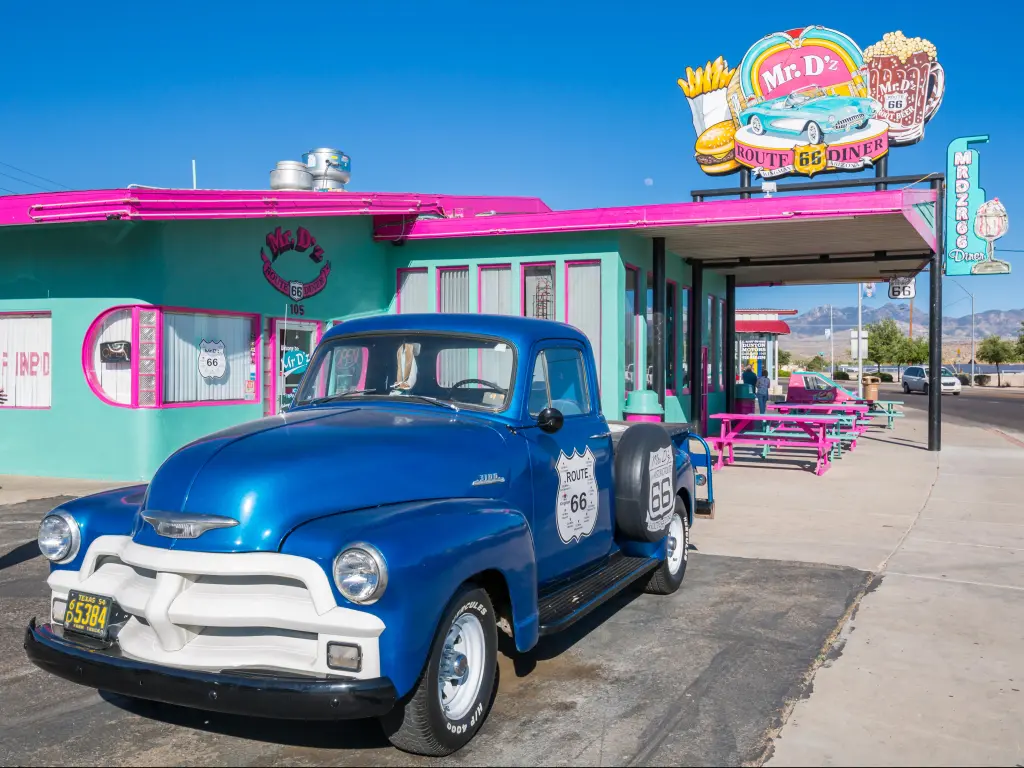 A vintage Station Wagon parked outside the brightly-colored Mr D'z Diner on Route 66 at Kingman, Arizona