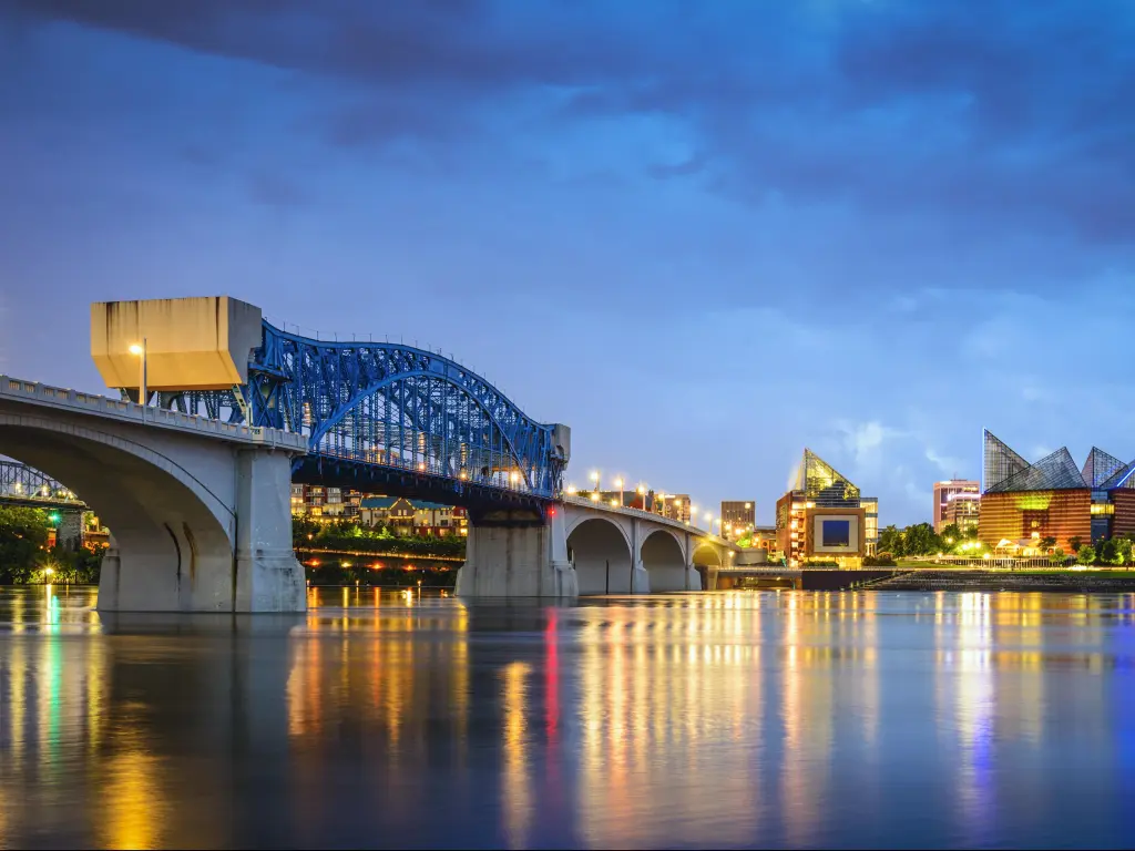 Chattanooga, Tennessee, USA with the downtown skyline taken at night and the bridge over the river in the foreground.