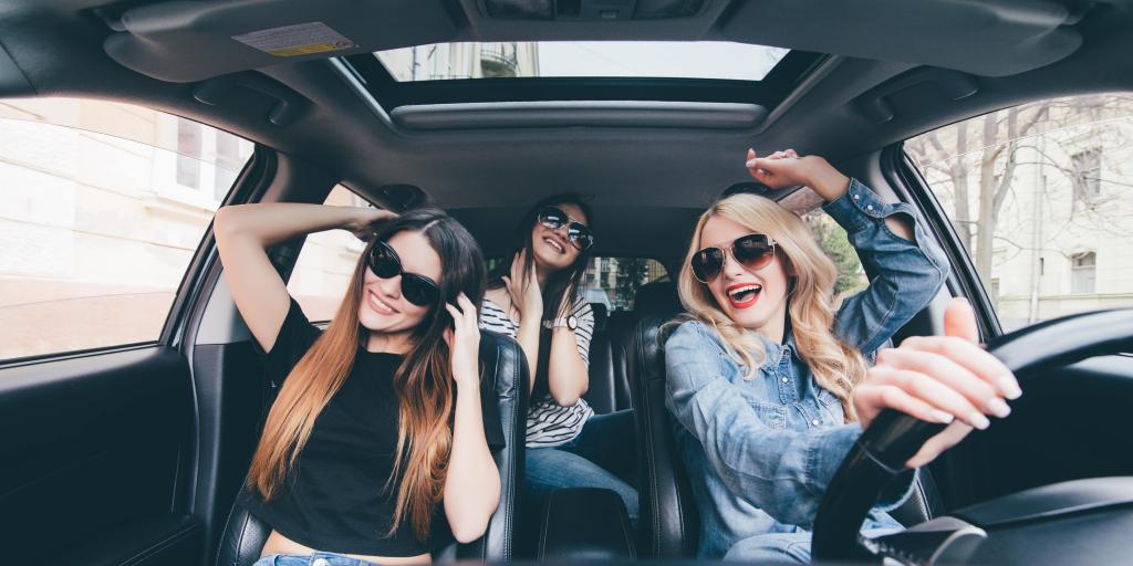Three girls singing in the car