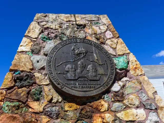 Historic metal marker on composite rock base monument for the National Pony Express Centennial
