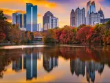 Atlanta, Georgia, USA with water in the foreground and Piedmont Park and the city skyline in the background reflecting in the water at autumn.