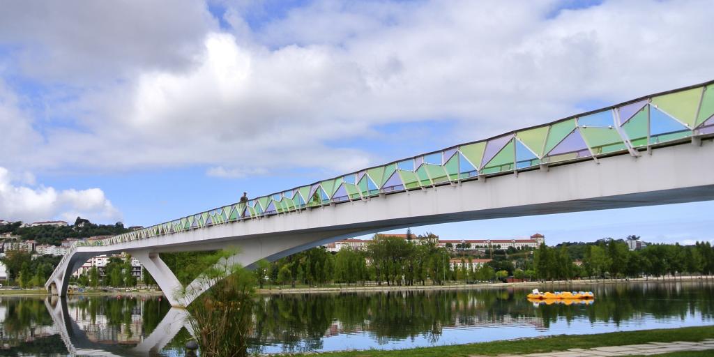 The colourful Pedro e Ines bridge in Coimbra crosses the Rio Mondego