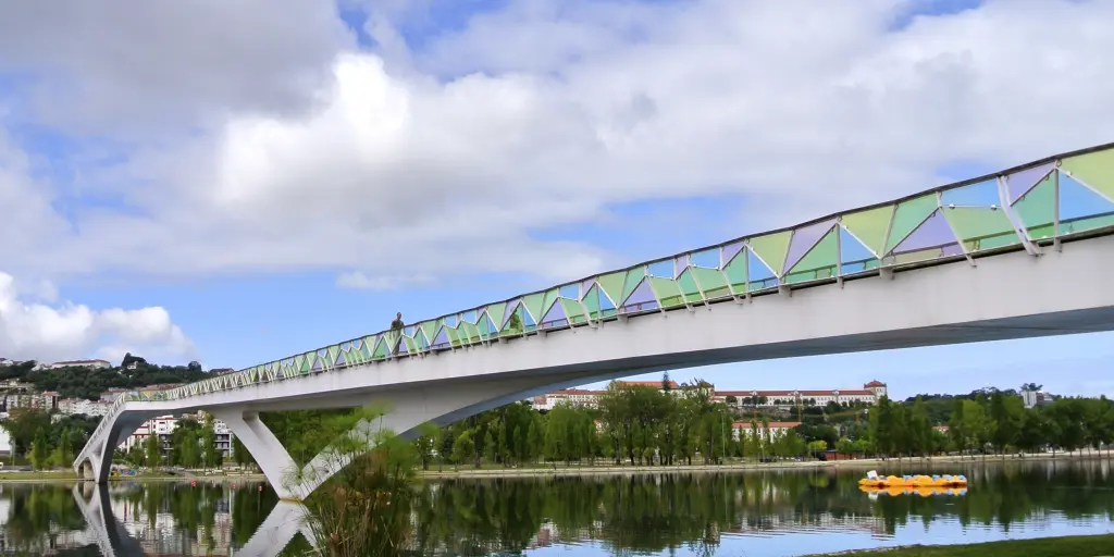 The colourful Pedro e Ines bridge in Coimbra crosses the Rio Mondego