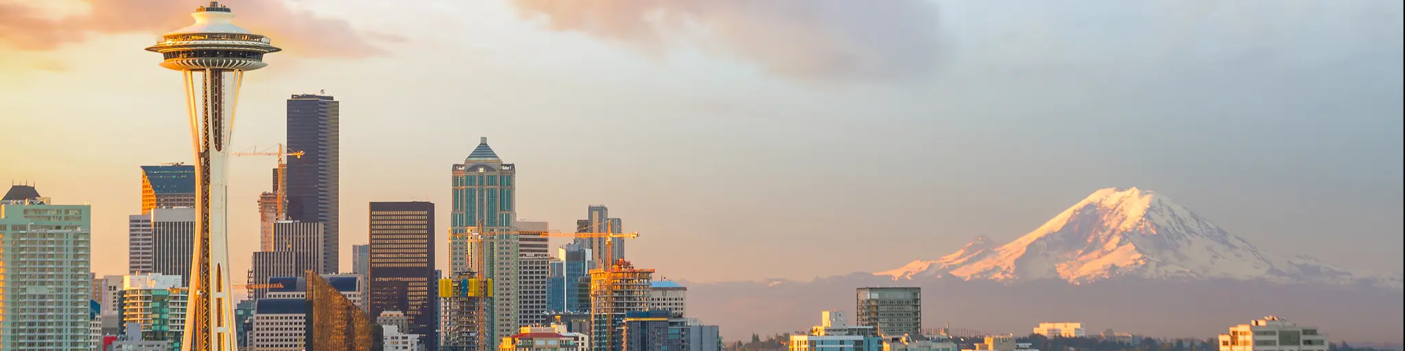 A panoramic view of downtown Seattle Skyline and the mountain at sunset on a fine day in Seattle, WA.