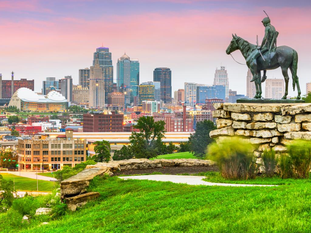 Kansas City, Missouri, USA with the city downtown skyline and park at dawn.