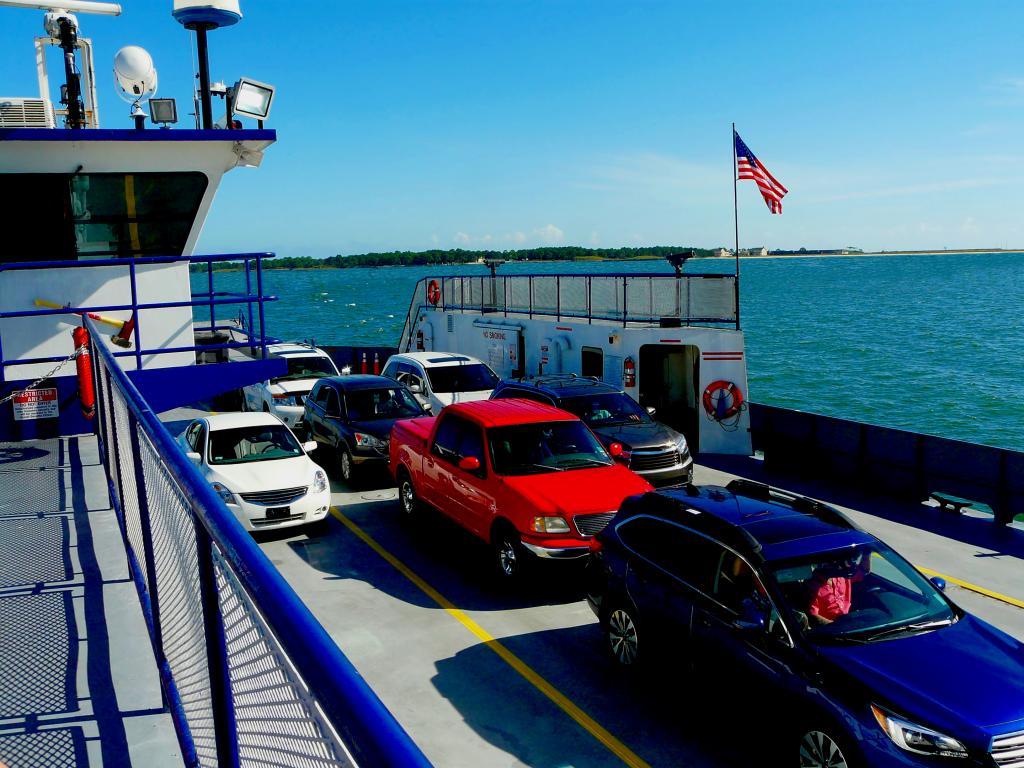 Cars onboard of a mobile ferry sailing across mobile bay going to Fort Gaines on a fine day 