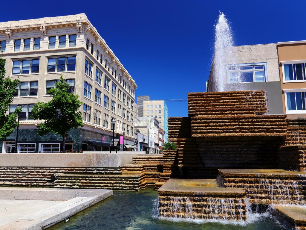 View from square of down town Springfield Missouri showing a waterfall in the foreground of buildings 