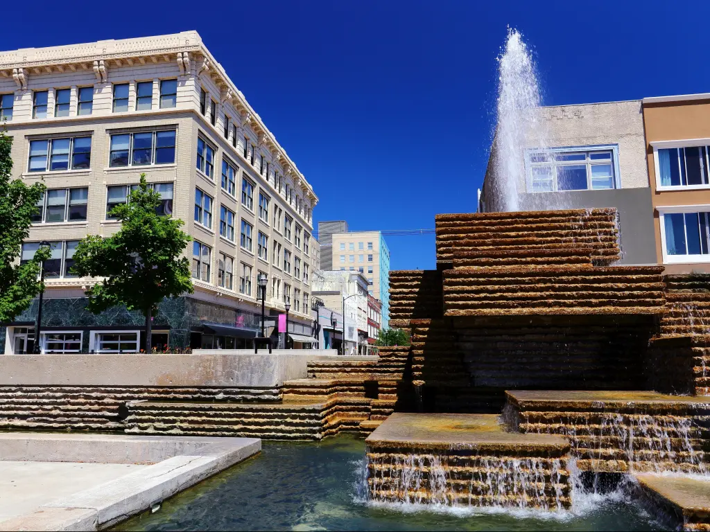 View from square of down town Springfield Missouri showing a waterfall in the foreground of buildings 