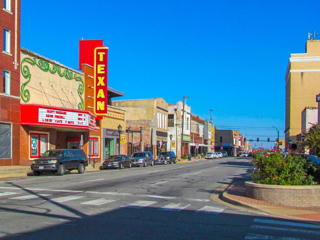 The quiet main street of Greenville, Texas on a clear summer day.