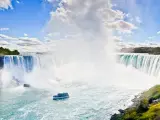 Horseshoe Falls with water droplets rising in the sky, boat in the water