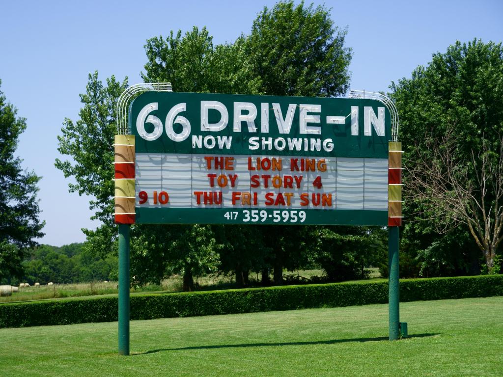 The historic Route 66 Drive-in sign, with a sign that shows what is currently on show