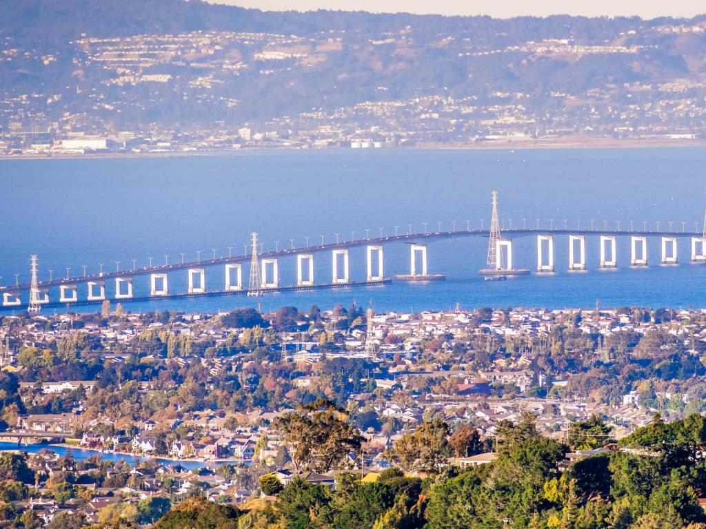 Aerial view of San Mateo Bridge, with Foster City visible in the foreground and part of the San Francisco Bay Area in the background.