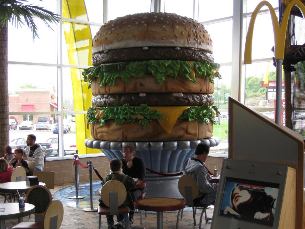 World's largest Big Mac, a statue in the Big Mac Museum in a McDonald's restaurant, with tables and diners around it