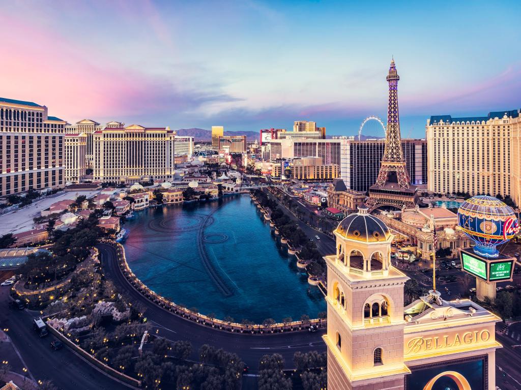 Las Vegas, Nevada, USA with a wide angle view of the Las Vegas Strip and city skyline at sunrise with dramatic sky.