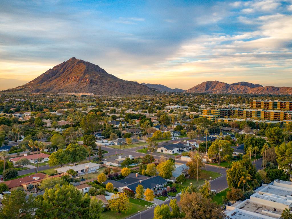 Scottsdale Arizona, USA with an urban sunset over downtown Scottsdale Arizona and the mountains in the distance.