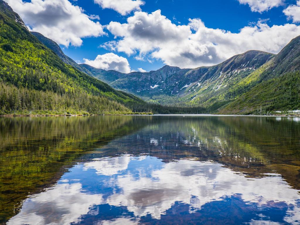 Gaspesie National Park in Quebec, Canada with a view on the "Lac aux Americains" (Americans' lake), with the glacial valleyed mountains reflected in it taken on a sunny and cloudy day.