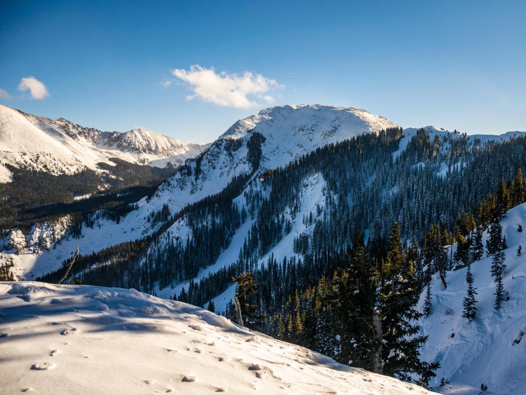 Taos Ski Valley, New Mexico, USA with the snow covered winter landscape high in the Rocky Mountains of Taos taken on a clear sunny day.