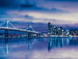 San Francisco, California, USA with a night view of beautiful San Francisco city skyline with lit buildings, bay and bridge.