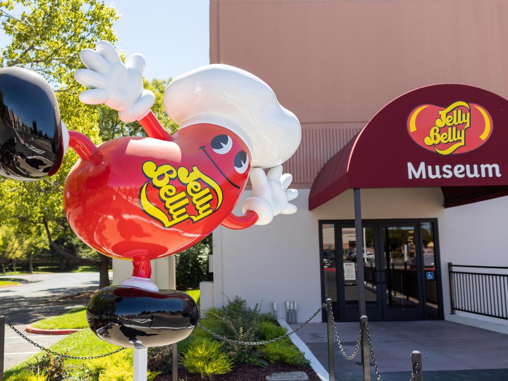 Giant Red Jelly Belly Statue jelly bean pointing the way to a museum at the factory location in Fairfield, California