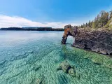 A rock formation called the Sea Lion with crystal clear waters on a sunny day