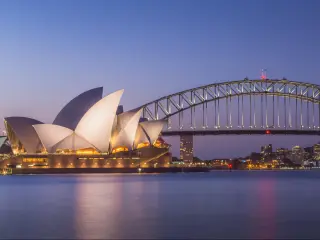 Sydney, Australia - January 4 2018: Summer evening twilight panoramic view of the iconic Sydney Opera House and Harbour Bridge from Mrs Macquarie's Chair in NSW.
