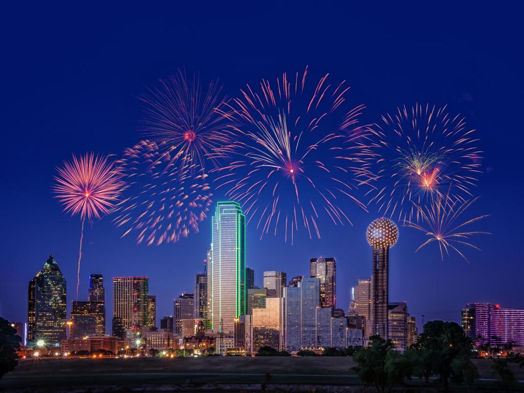 Firework display above the cityscape of Dallas on a dark evening